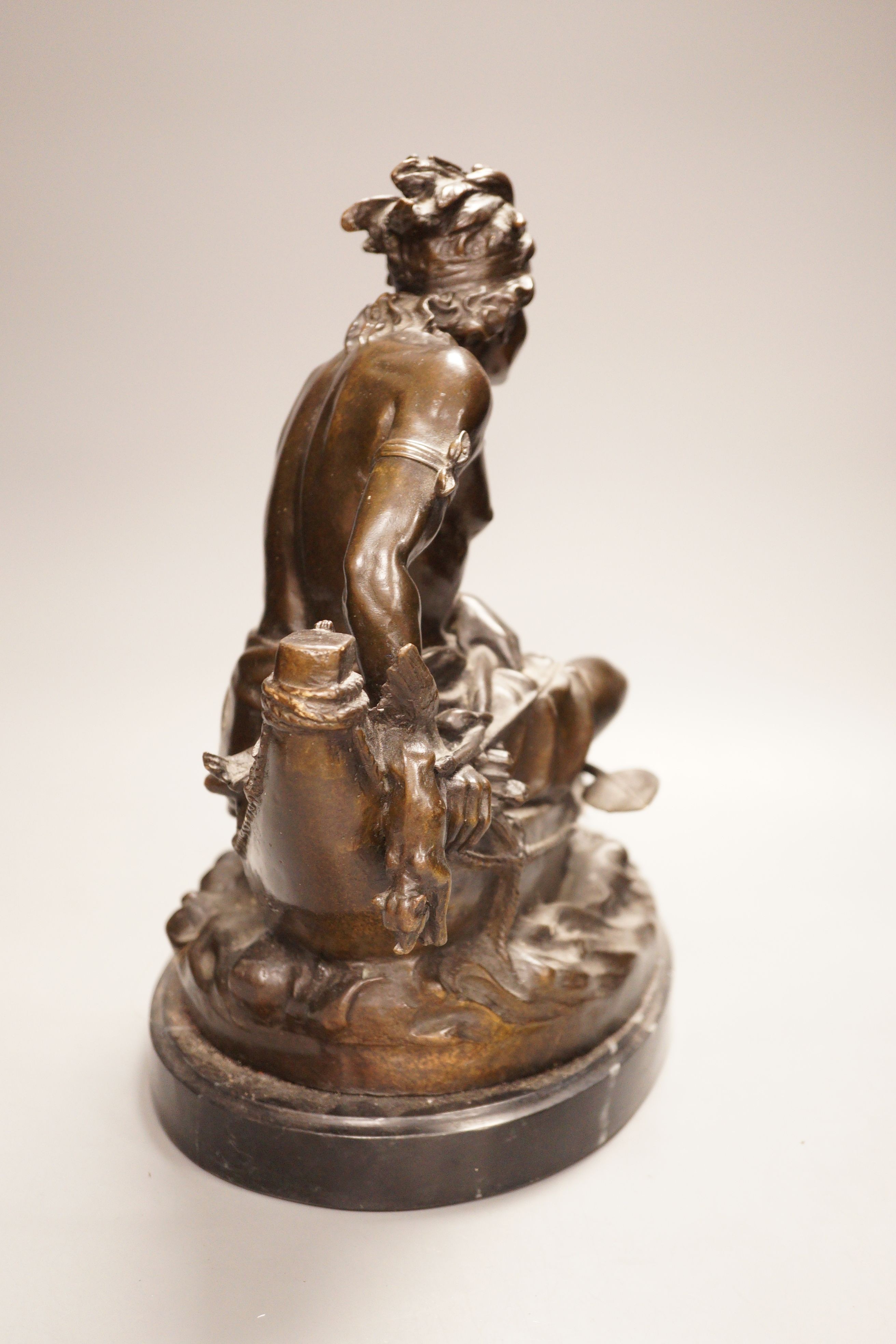 After Duchoiselle, a bronze study of a Native American huntsman in canoe, with impressed mark, on marble base, 30cm tall